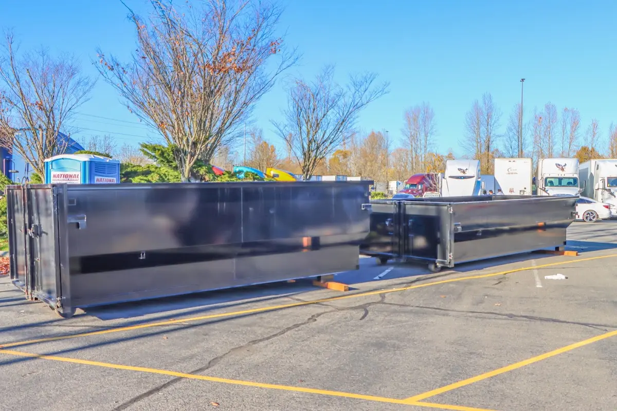 Professional dumpster rental service with roll-off container on residential driveway in Grosse Pointe Farms
